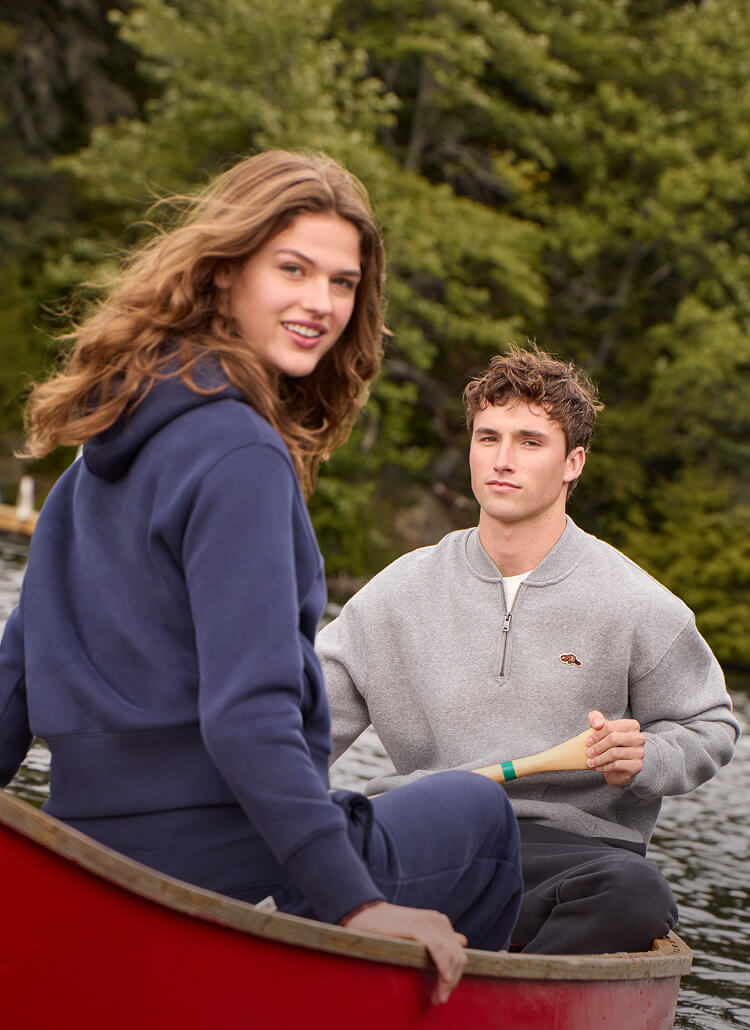 Woman and man wearing fall Roots styles together in a canoe.