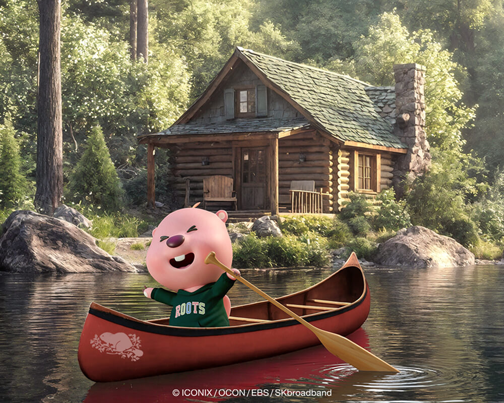 ZANMANG LOOPY in a canoe in front of a cabin by the water