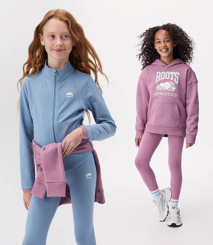 Two kids wearing activewear in blue and pink.
