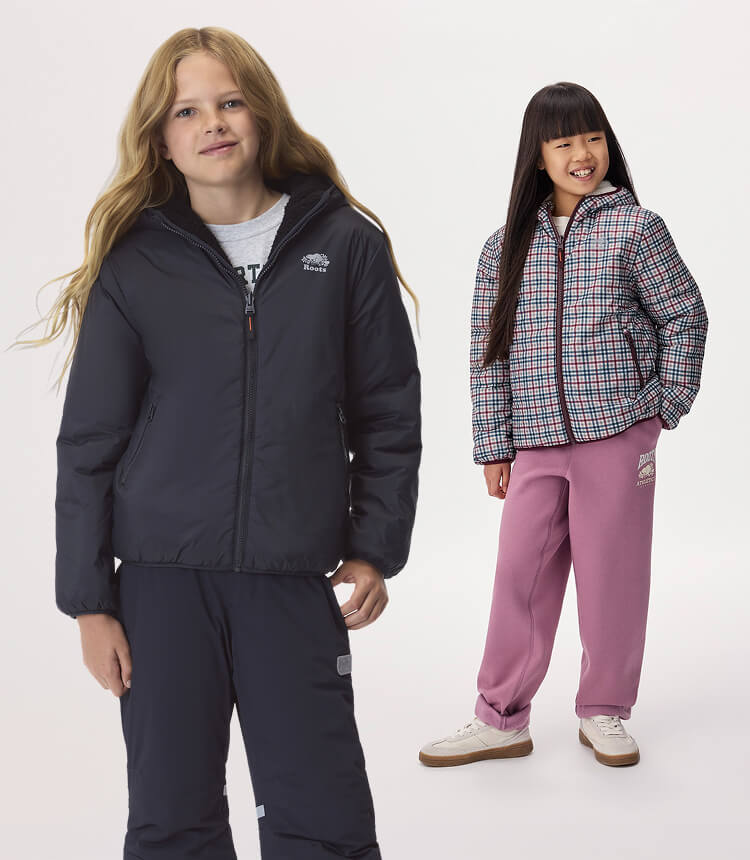 Two kids wearing activewear in blue and pink.
