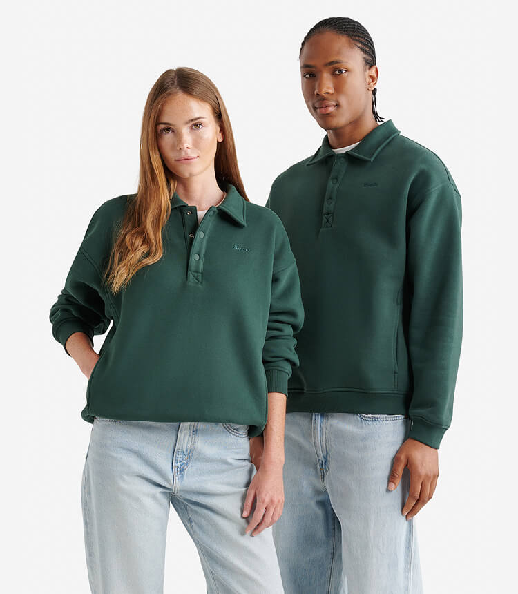 Two models wearing red Canada hoodies and blue jeans.