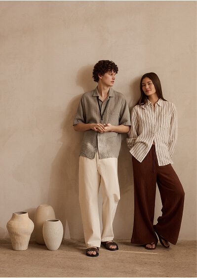 Two models wearing Isla Cotton shirts and wide leg pants.